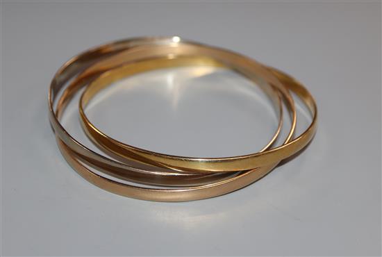 A set of three 18ct two-colour gold interlinked bangles, gross 41 grams.